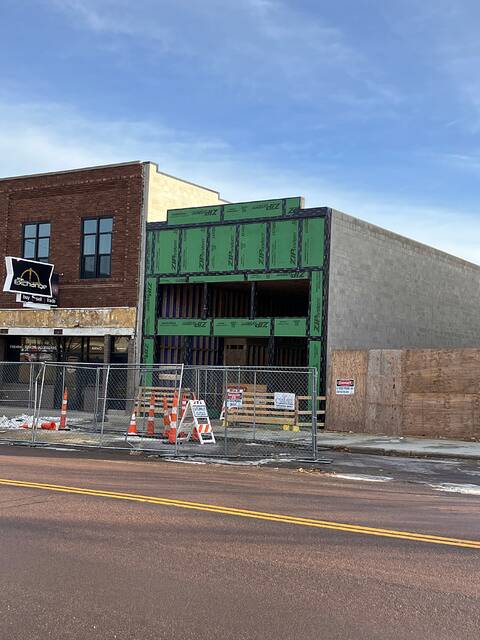 Significant progress is being made nearly a year after a blaze scarred downtown Brookings. From left are The Exchange, Seven Songbirds Boutique, and an empty space where Brosts Fashions plans to rebuild sometime in 2026.
                                 Beverly Jensen/Brookings Register