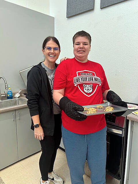 Alysha Hamann, like skills special education teacher at Mickelson Middle School, and Donavon Thompson are ready to put some cookies in the oven.