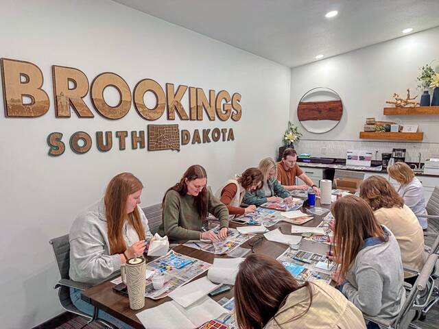 Brookings Regional Growth Alliance staff paint their mural tiles.