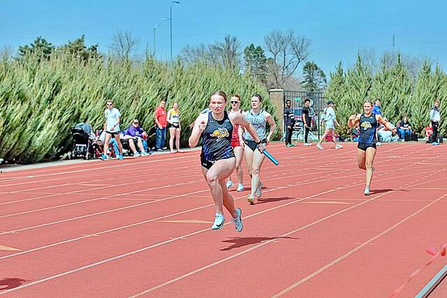 An SDSU relay team competes at a track meet.