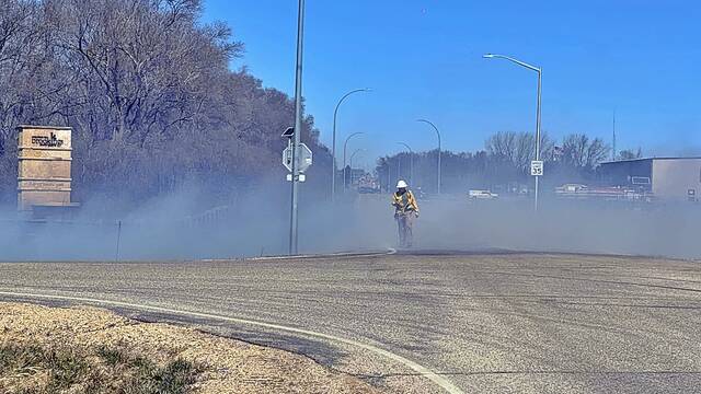 Smoke billows across a roadway near Dakota Nature Park on April 12 as firefighters battled a grass fire.
                                 Alex Post/AP Media & Filming