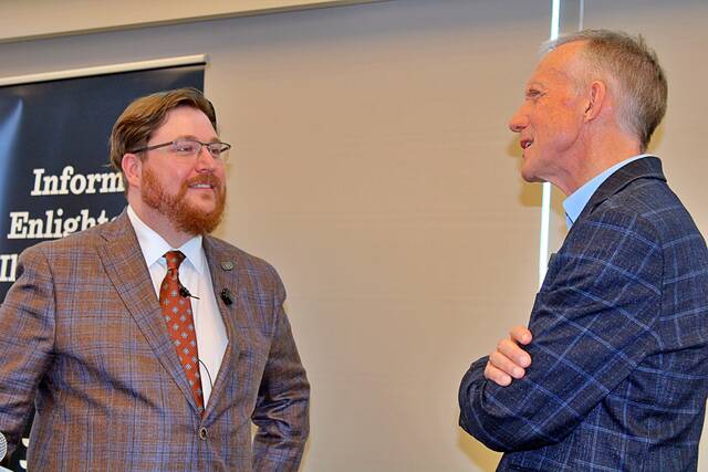 Jon Ruff, an assistant professor of political science at South Dakota State University, and Carson Walker, chief executive officer of South Dakota News Watch, share a moment on April 14 during a community conversation on the 250 years of American media and politics. The event, held in the Woster Celebration Hall in the SDSU Alumni and Foundation Building, centered on the history of civics and news voter apathy and the guaranteed freedoms Americans enjoy.
                                 Brian Bloom/Brookings Register
