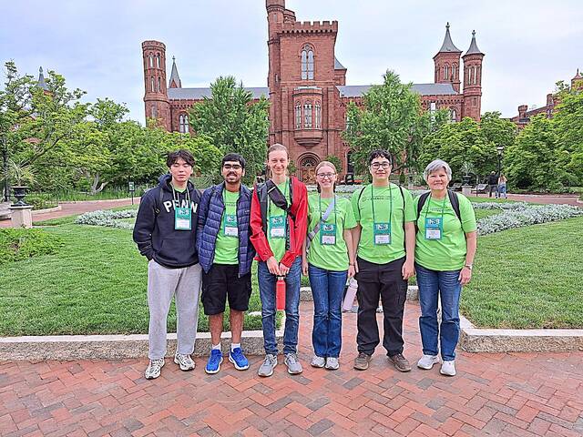 From left: Quinton Zhu, Shaurya Sehgal, Joseph Michna, Catie Michna, Waylon Lowe and coach Ronda Kantack at the Smithsonian castle.