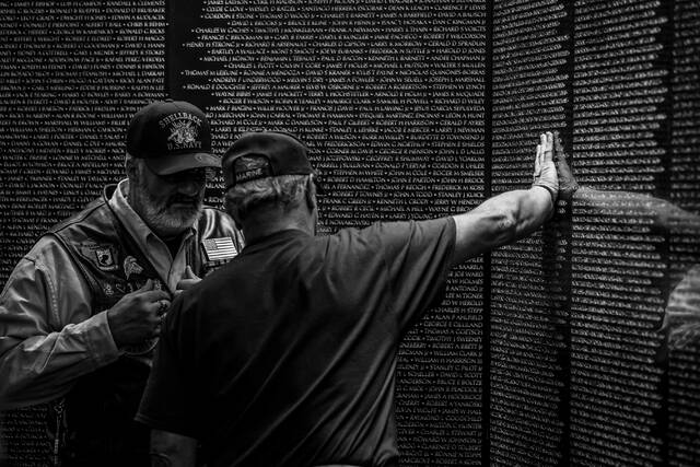 Veterans visit an apex panel at The Wall That Heals during the overnight hours.
Photo courtesy Vietnam Veterans Memorial Fund